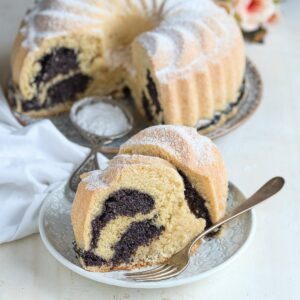 Stücke von Gugelhupf mit Mohnfüllung, auf dem Dessertteller.